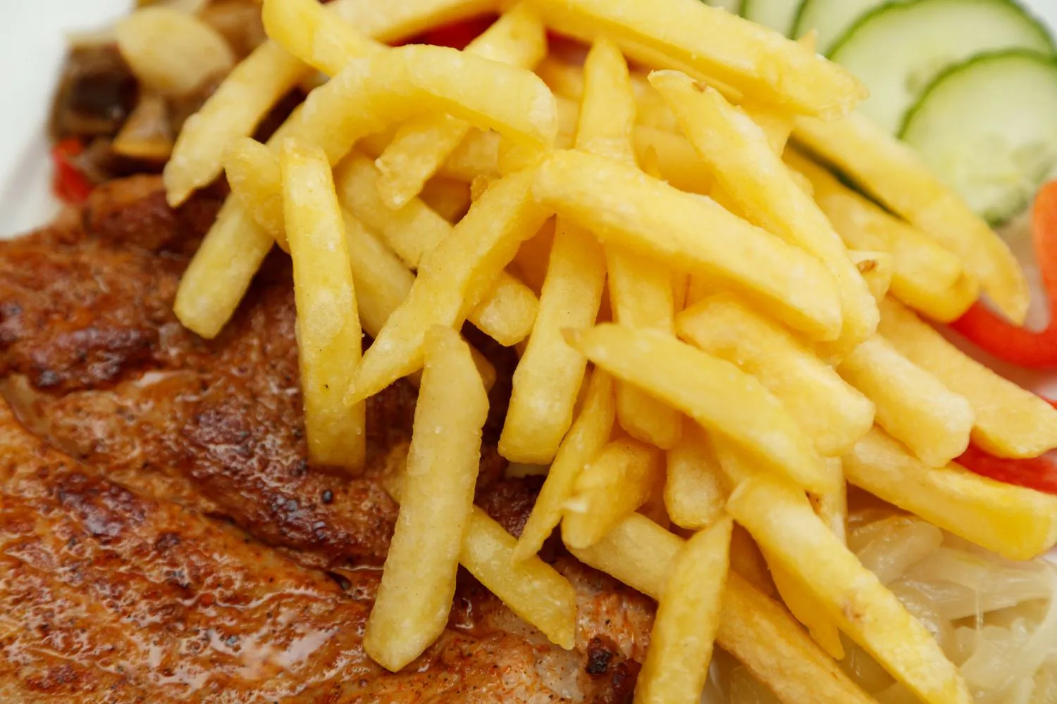 Golden french fries served with grilled meat at MBL & Q Burger, a Fried Chicken Shop in Irvine