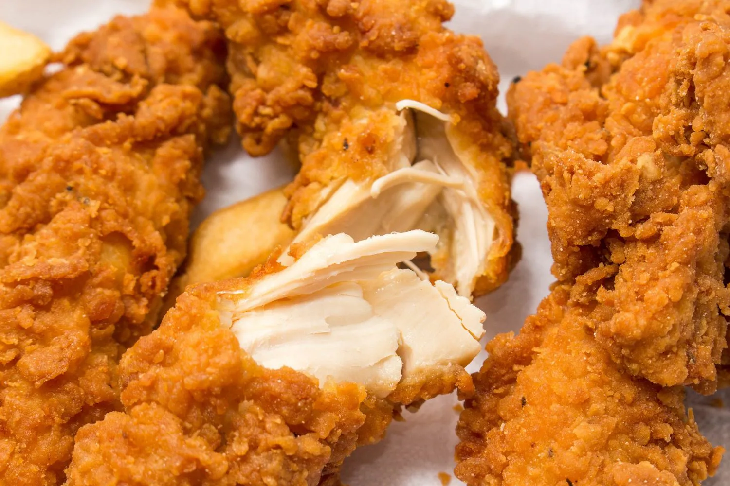 Crispy fried chicken tenders with tender white meat inside at MBL & Q Burger, a Fried Chicken Shop in Irvine