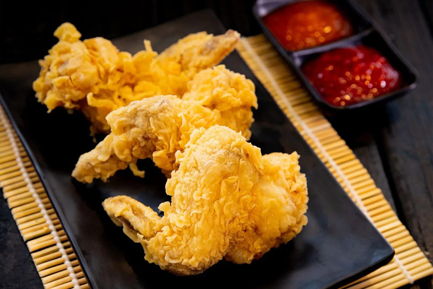 Crispy fried chicken wings with dipping sauces at MBL & Q Burger, a Fried Chicken Shop in Irvine