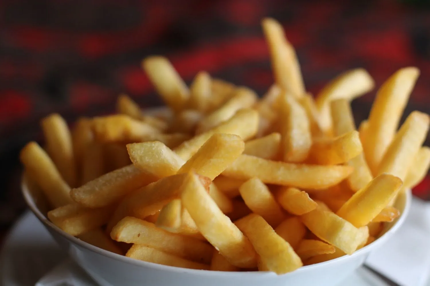 Crispy golden french fries in a white bowl at MBL & Q Burger, a Fried Chicken Shop in Irvine